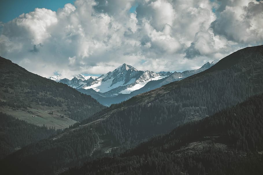 landscape photo of alps surrounded by trees, snow-covered mountain under cloudy sky HD wallpaper