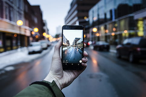 person holding iPhone while taking photo of asphalt road, person holding opened black Android smartphone HD wallpaper