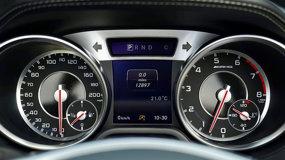 black and silver automotive gauge cluster with digital interface