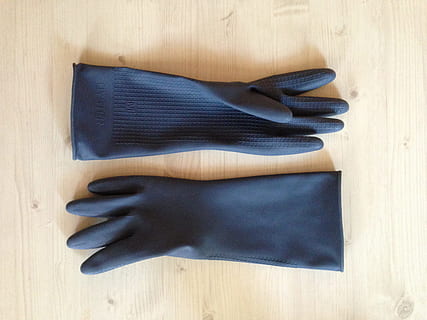 pair of gray hand gloves on top of brown wooden plank, rubber HD wallpaper