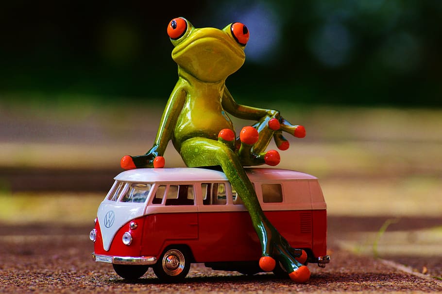 green frog toy sitting on a red Volkswagen T2 van toy, vw, bulli