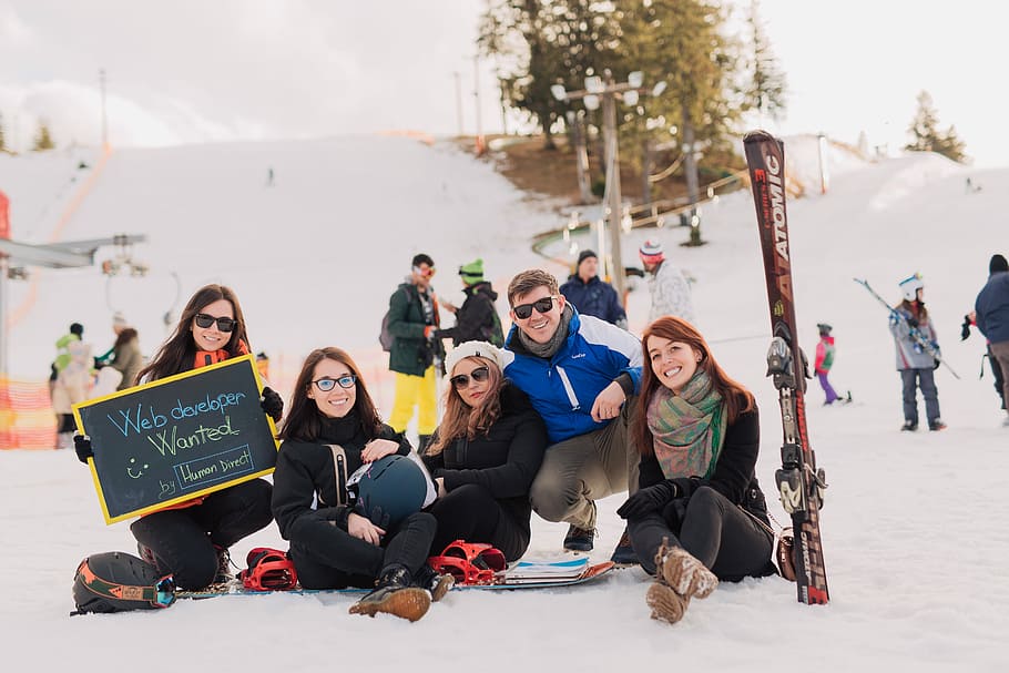 group of people sitting on snow taking photo, people sitting on snow during daytime HD wallpaper