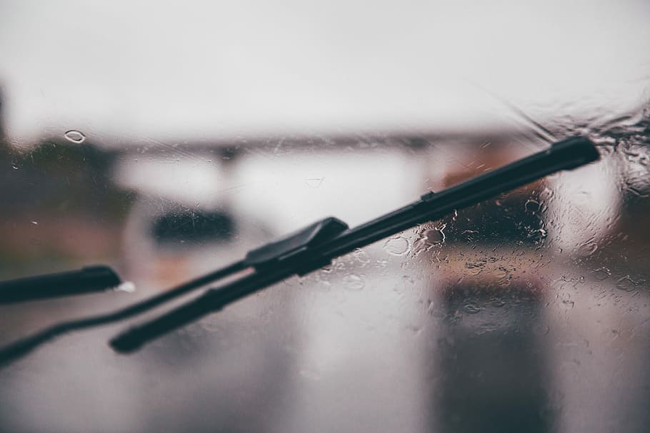 shallow focus photography of black vehicle wiper, wiper wiping vehicle windshield