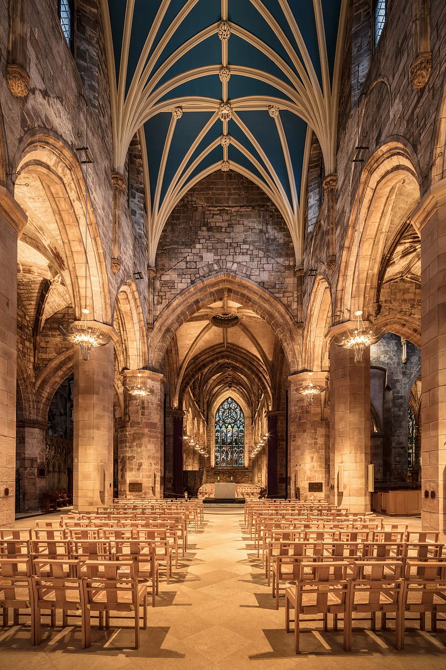 well lit brown concrete building with brown wooden chairs and brown chandeliers, cathedral interior HD wallpaper