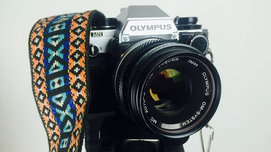 Black and Gray Olympus Dslr Camera White Orange Blue and White Strap HD wallpaper