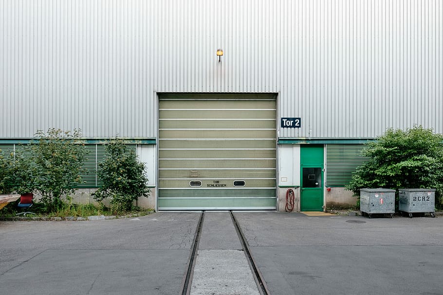closed garage door, gray building with roller shuter, urban, wall