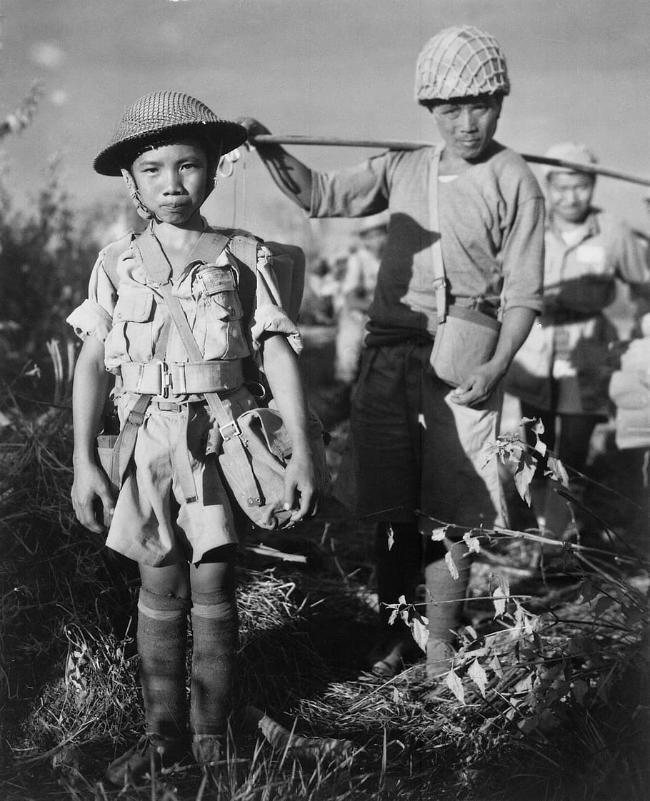 grayscale photo of people standing on grass field, Child Soldiers
