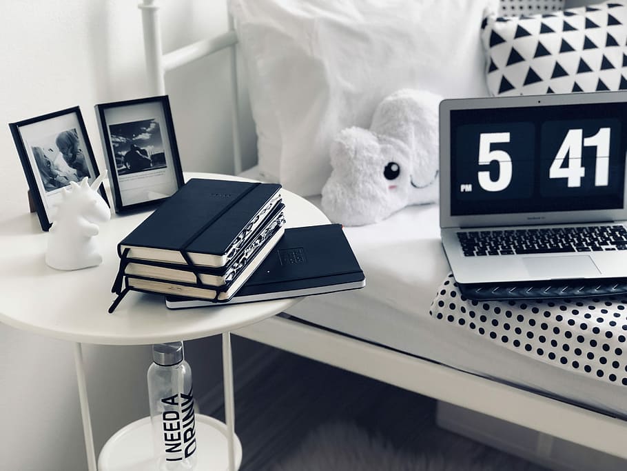 books on round white table, assorted-color notepads on white nighstand HD wallpaper