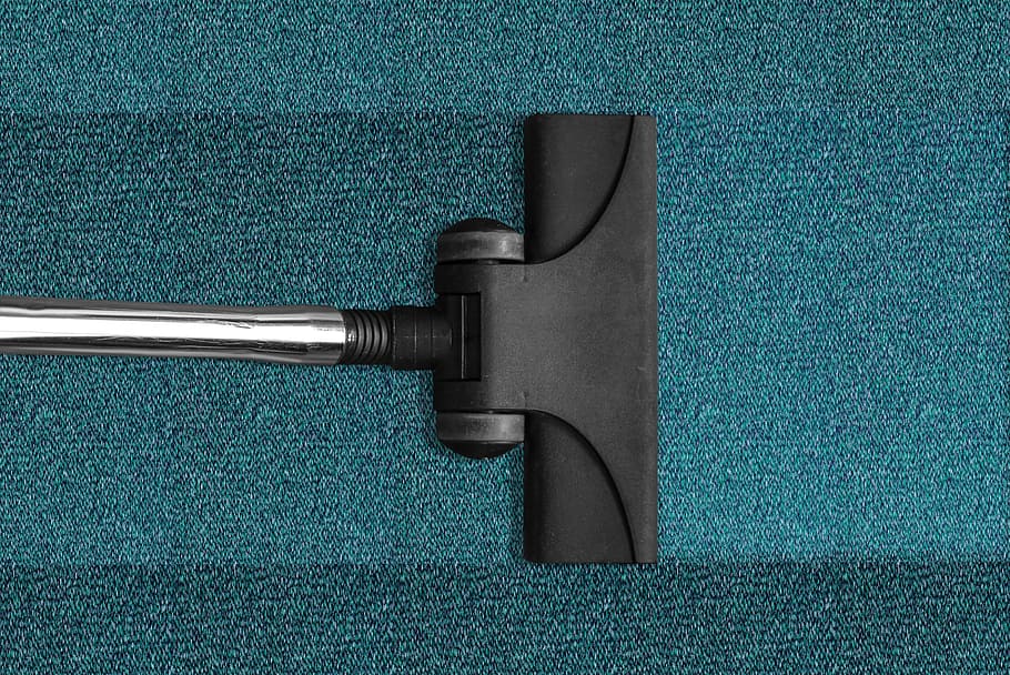 black and gray steam mop on blue mat, silver steel, vacuum cleaner