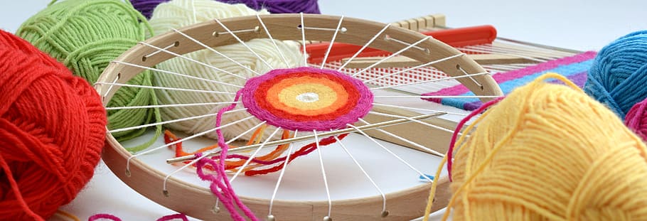 round brown wooden frame with assorted-color threads and yarns HD wallpaper