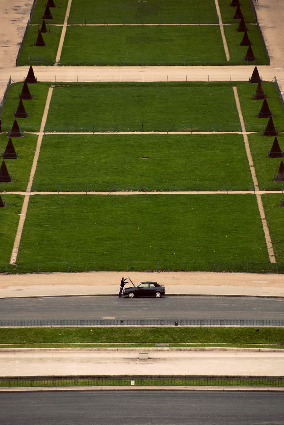 landscape photography of green field during daytime, man standing in front of black car HD wallpaper