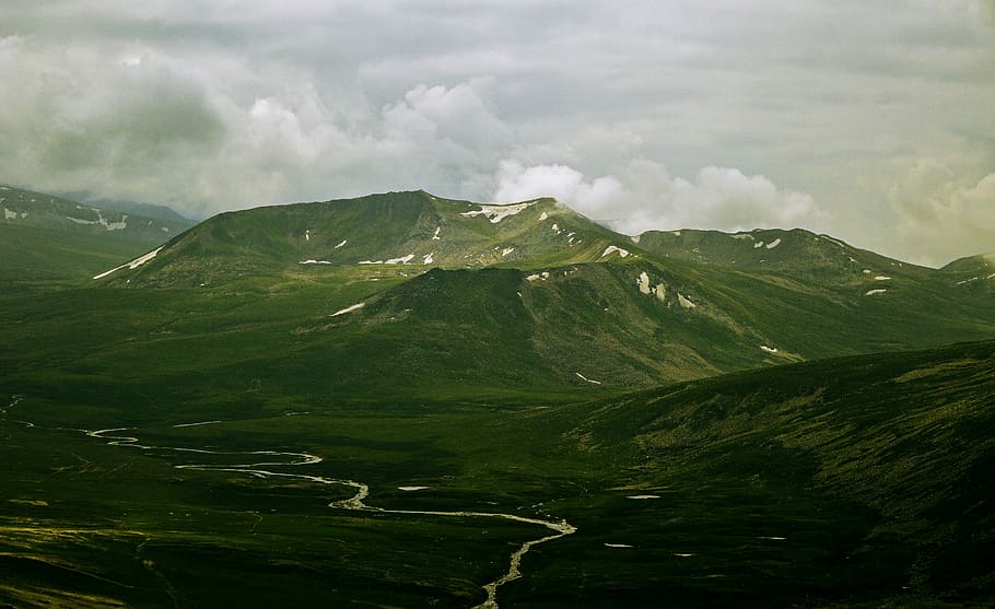 mountain under the skies, river surrounded by mountain range under gray sky HD wallpaper