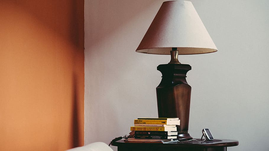 pile of books beside brown table lamp, black and brown table lamp on brown top HD wallpaper
