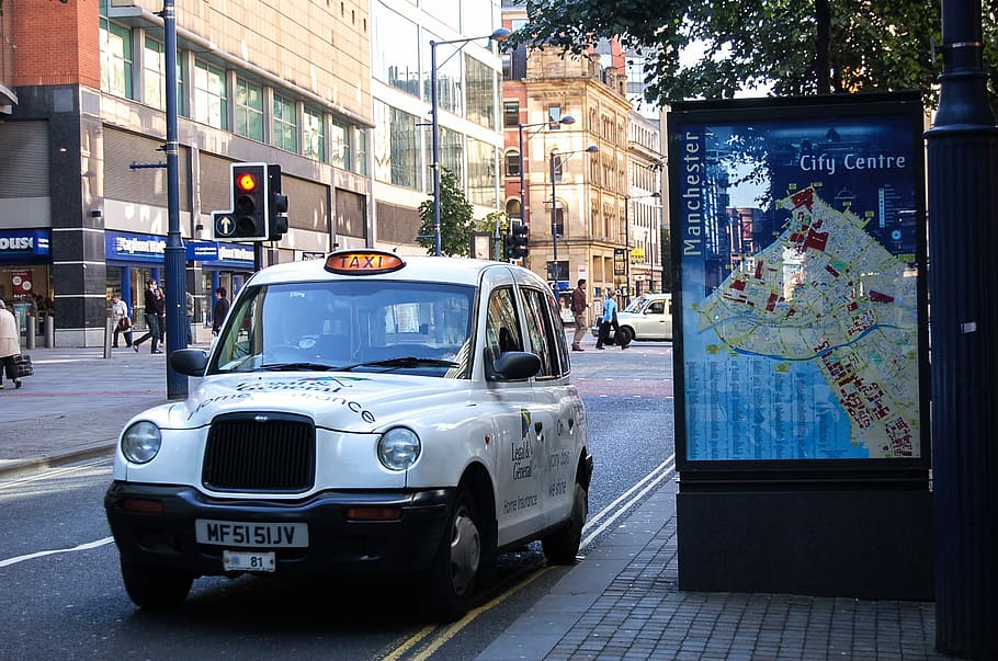 white taxi parked near city map illustration, Inner City, Manchester, England