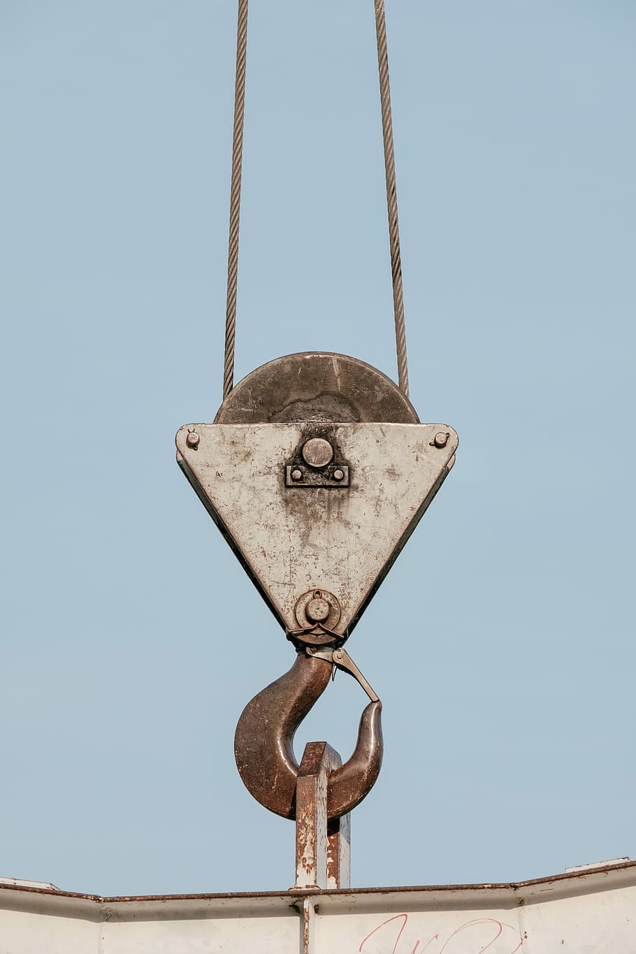 brown steel pulley holding white steel bar, gray metal winch hook carrying metal box HD wallpaper
