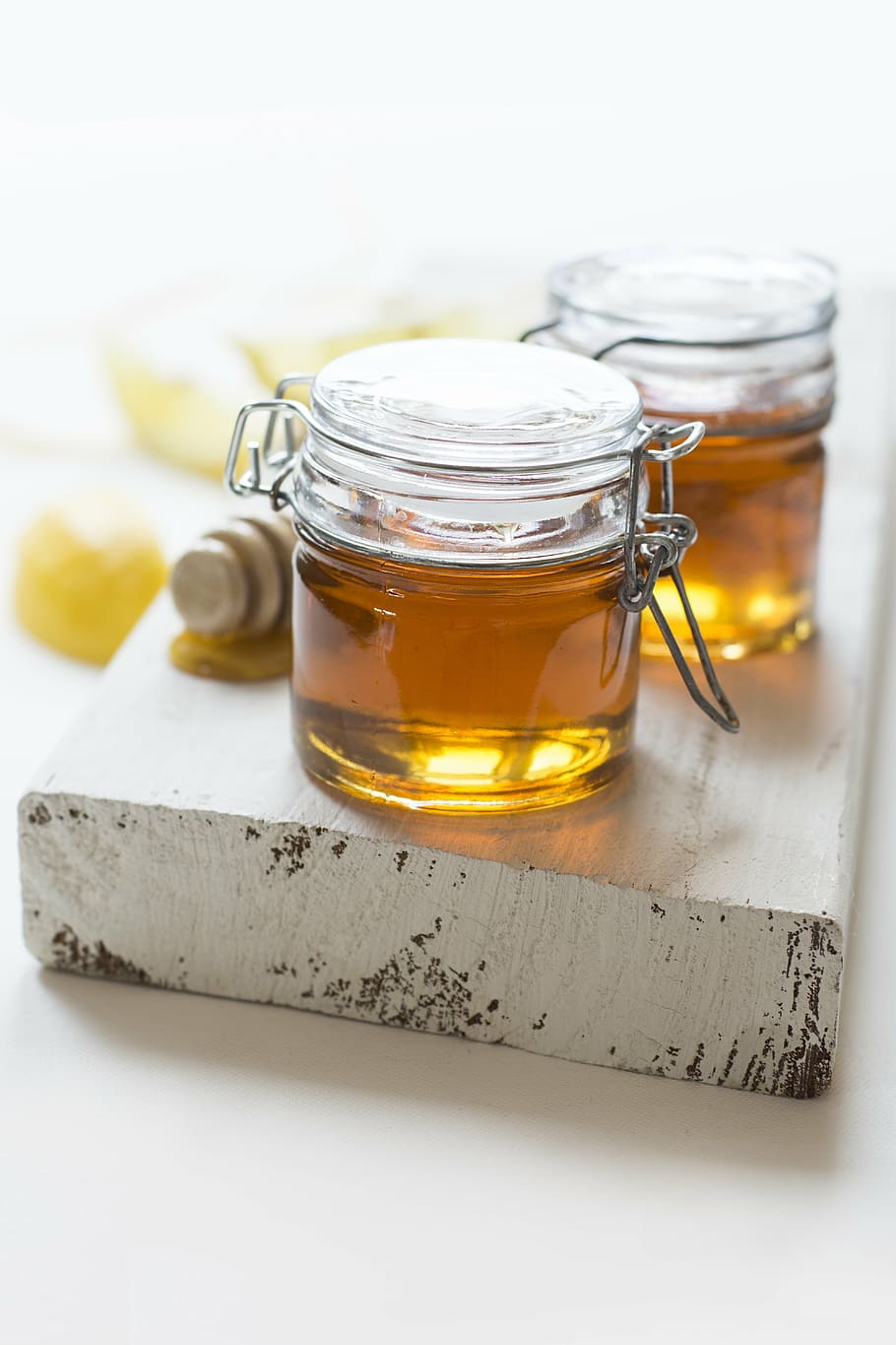 two clear glass hermetic jars with brown liquid, dandelion, the syrup