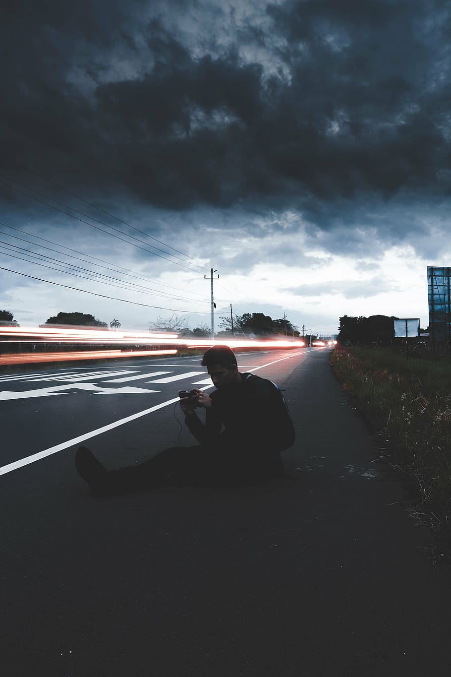 man sitting beside road, light, dark, cloud, sky, people, guy HD wallpaper