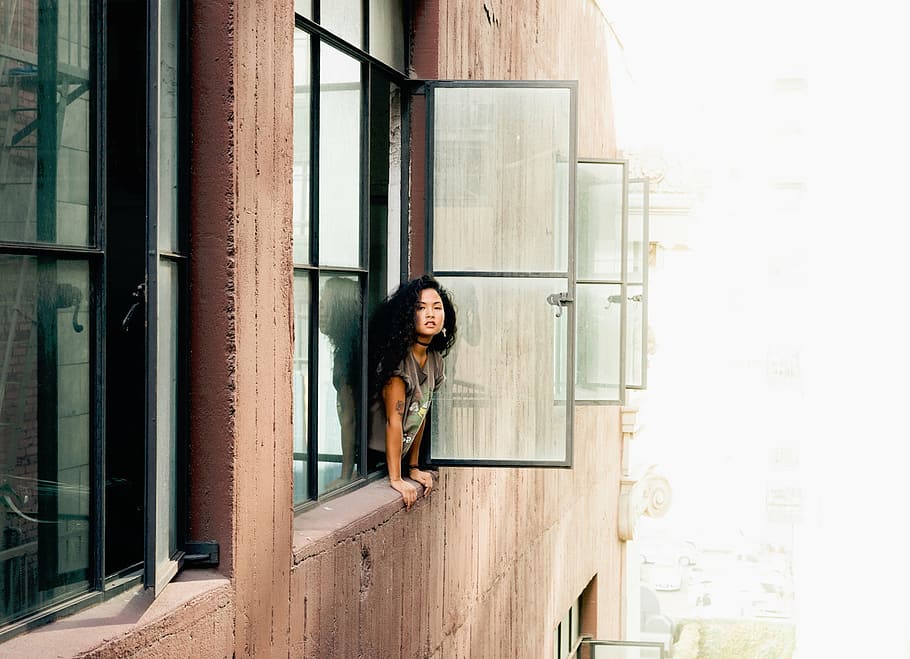 woman looking out the window during daytime, building, apartment