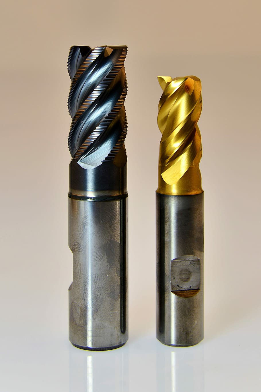 selective focus photography of two drill bits, milling cutters
