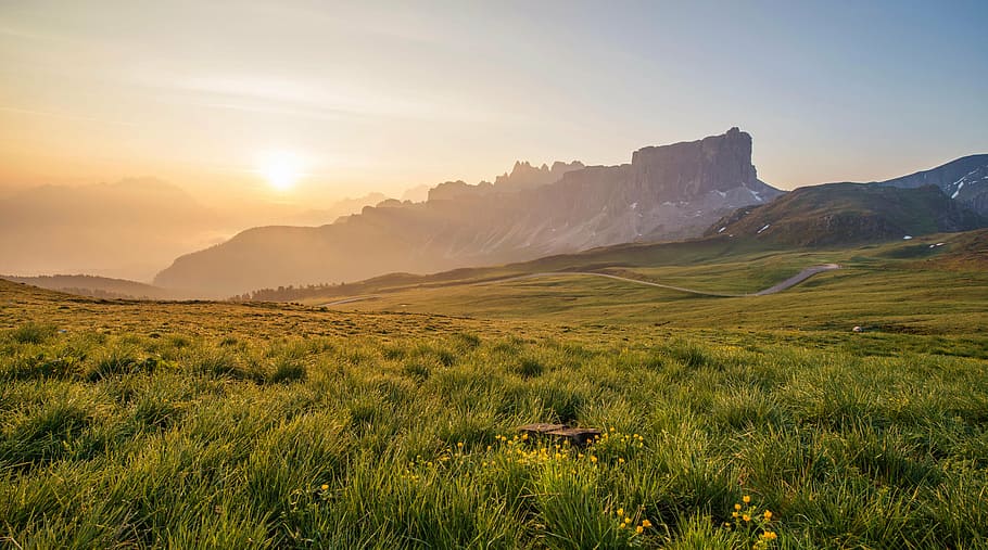 green grass field near mountain at daytime, photo, sunrise, scene, HD wallpaper