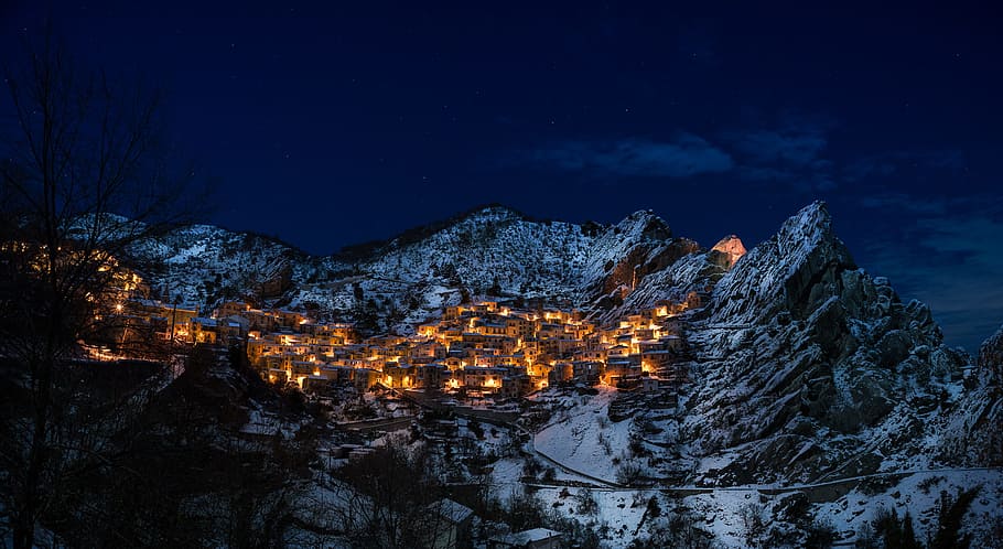 mountain during night, village in the middle of mountains turn-on lights