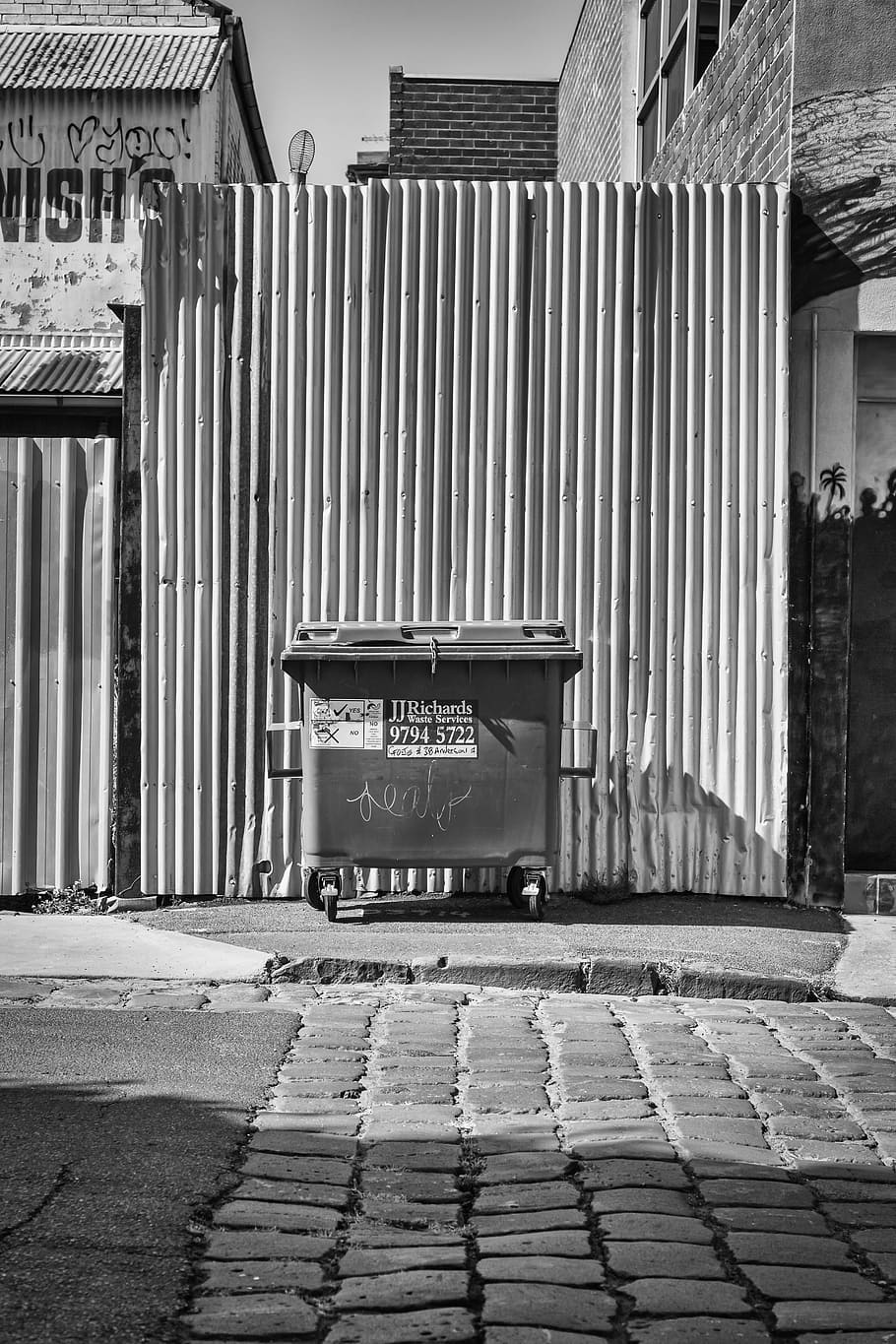 grayscale photo of rolling garbage can, fence, bin, pavement HD wallpaper