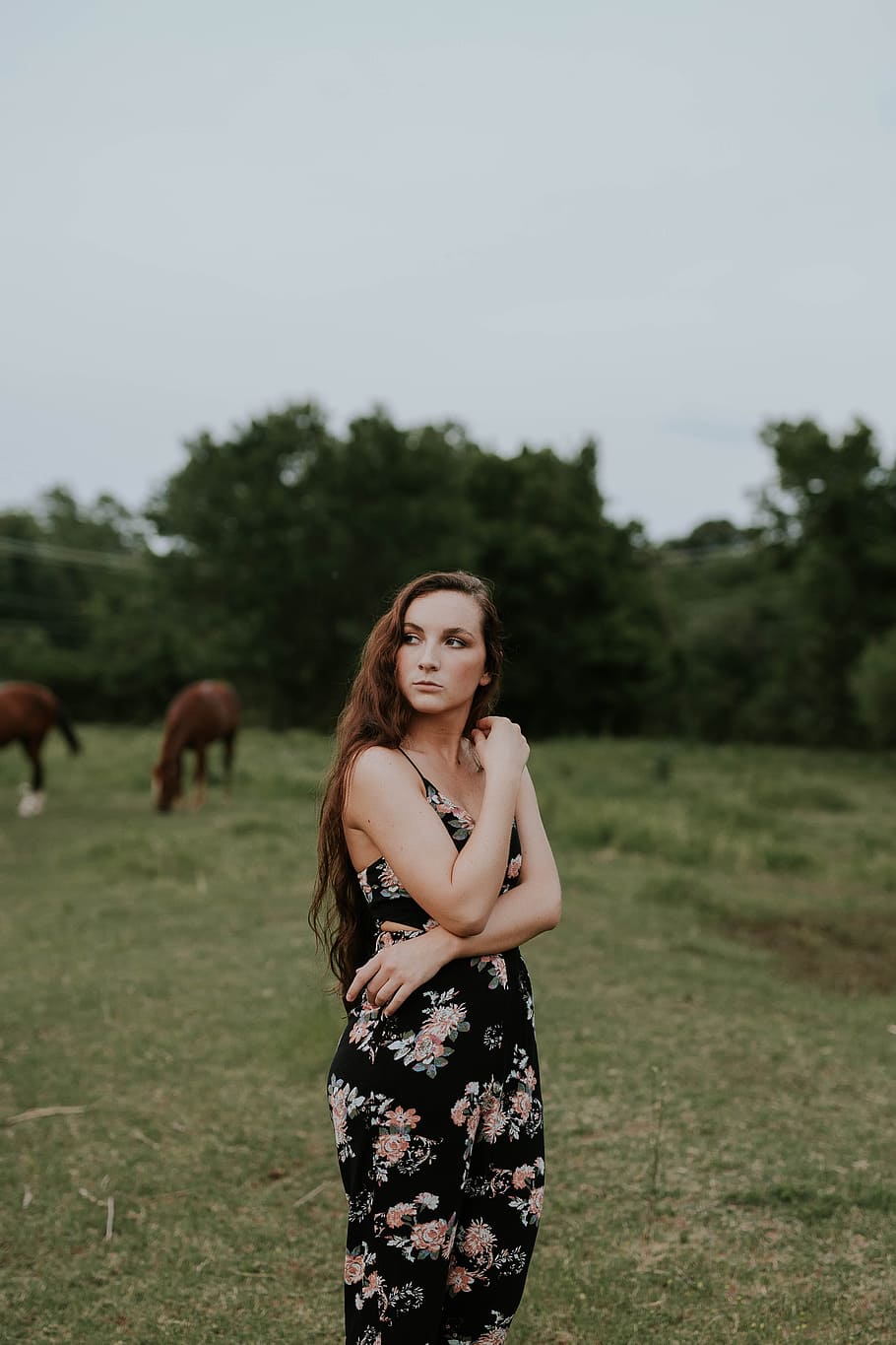 A Woman in a Red Halterneck Jumpsuit Holding a Fabric · Free Stock Photo