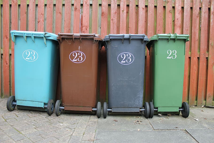 four assorted-color garbage cans, wheelie bin, rubbish, waste