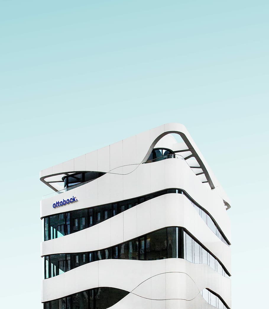 white and black Ottobock building, white concrete building, sky HD wallpaper
