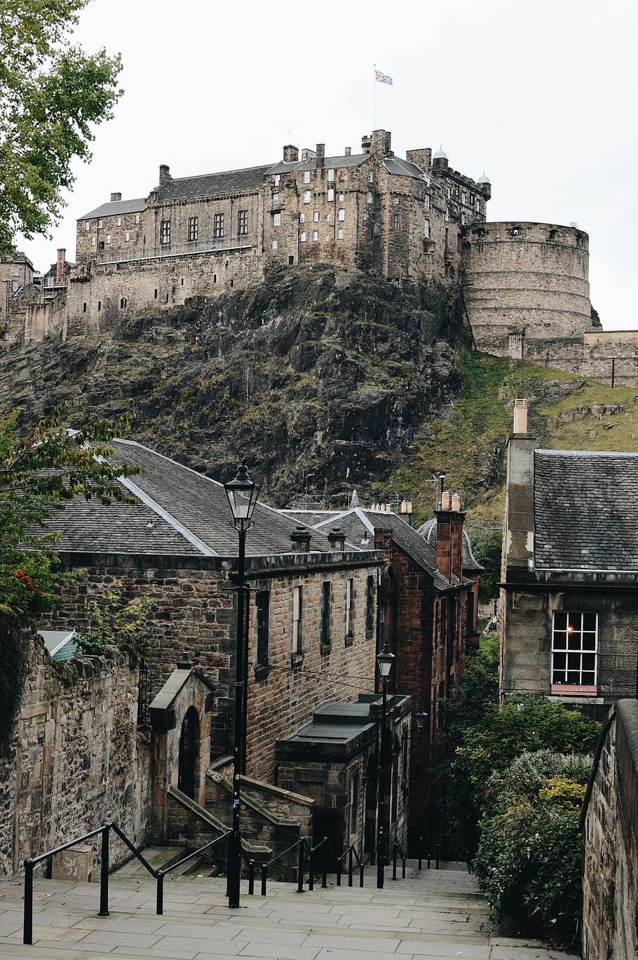 brown castle on top of the hill under gray sky, castle with flag HD wallpaper