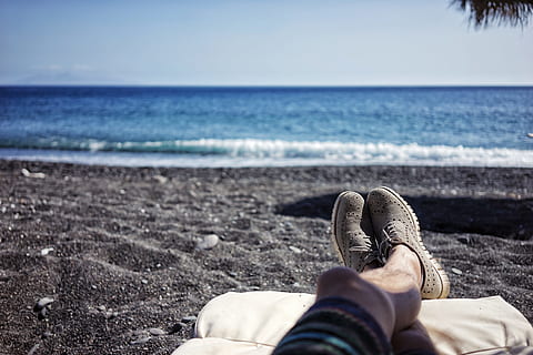 body of water in beach, person lying at the beach during day HD wallpaper