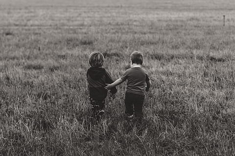 two boy's walking on green grass field, two toddlers walking on grass field during daytime HD wallpaper