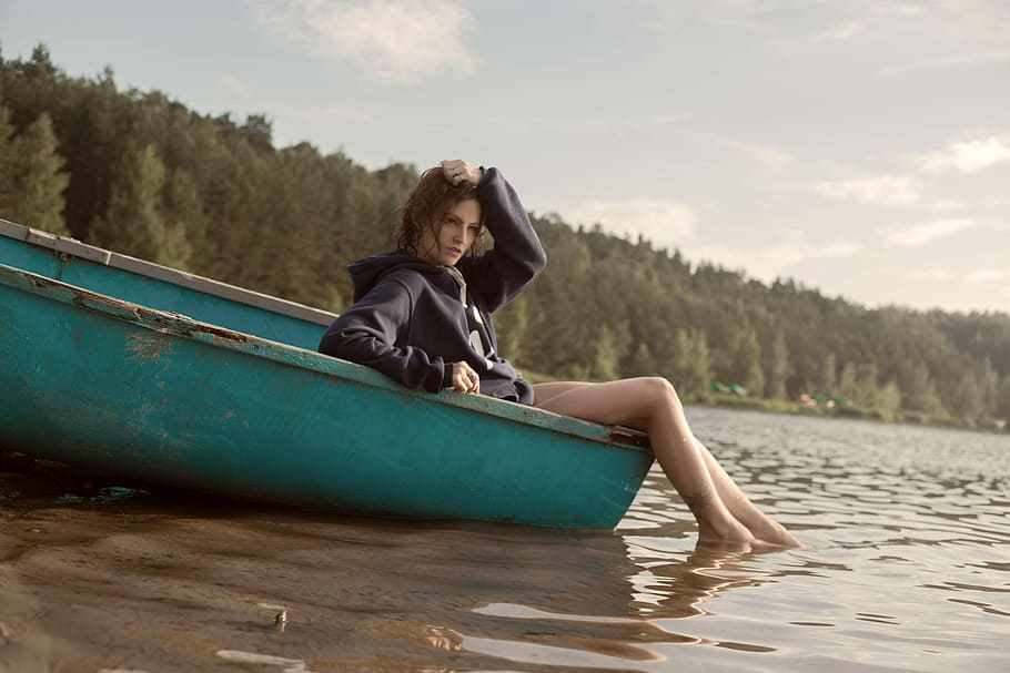 Girl sitting in Canoe with feet in water in the summer, beautiful
