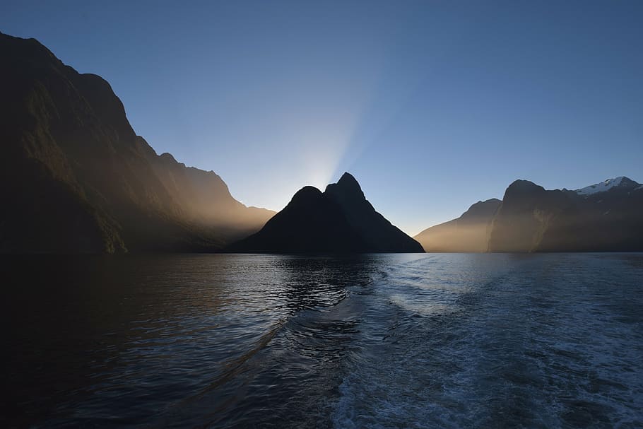 mountain on body of water, sea, ocean, waves, nature, mountains HD wallpaper