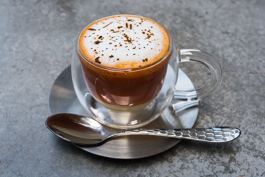 coffee latte with mug, saucer and tea spoon on gray concrete surface, HD wallpaper