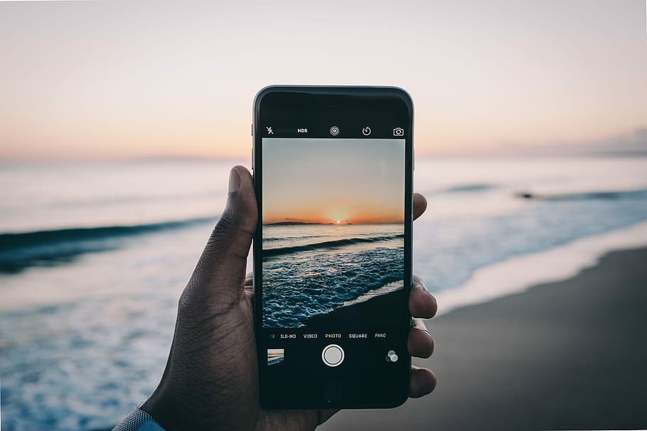 person talking selfie of sea shorre, photography of seashore during sunset HD wallpaper