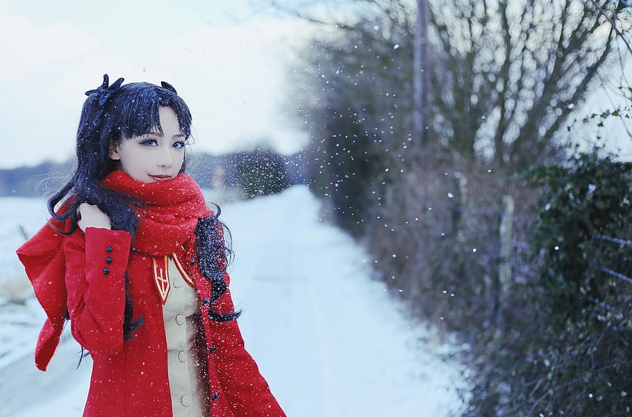woman standing on snowy road, photo of woman in Fate Stay Night Rin cosplay