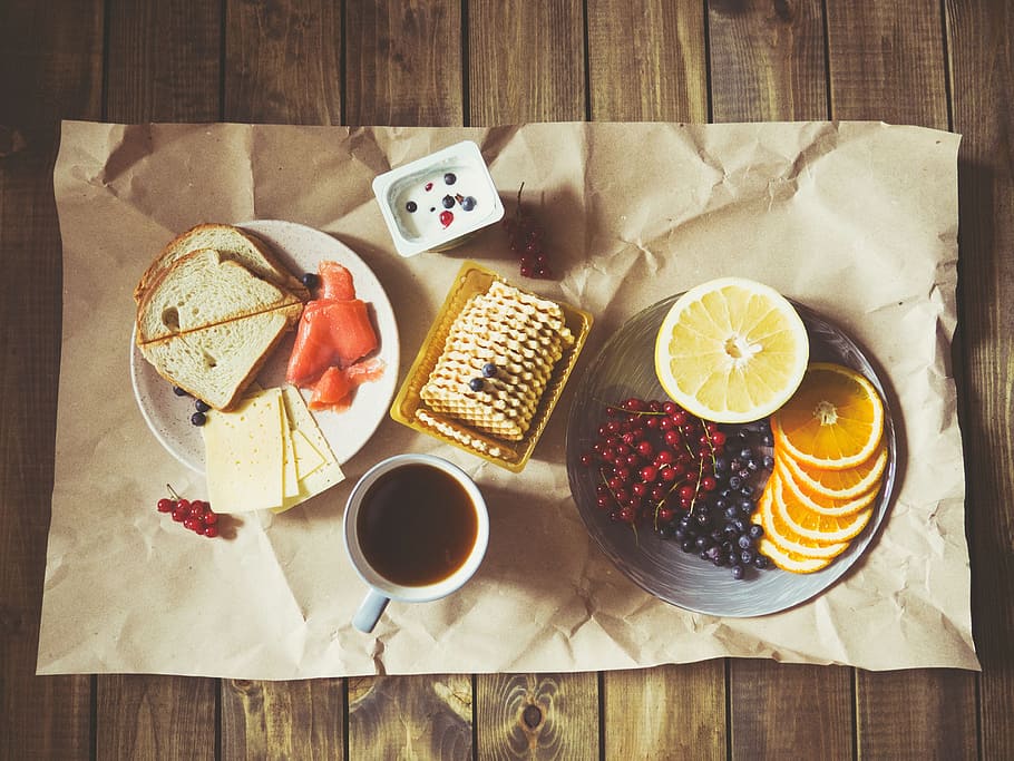 white ceramic mug filled beside white plate and biscuit tray on brown surface HD wallpaper