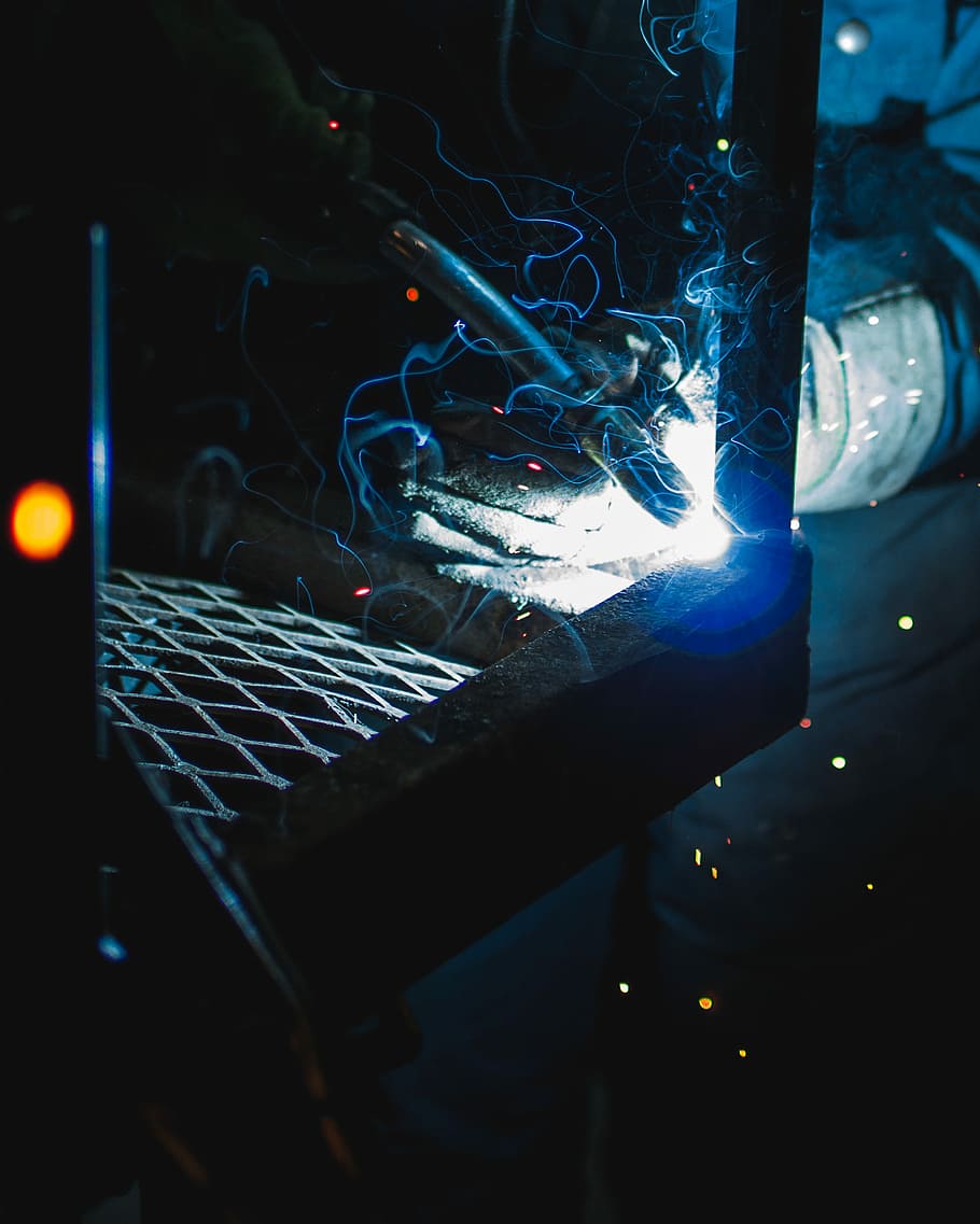 person holding a welding equipment, static cutting torch photography