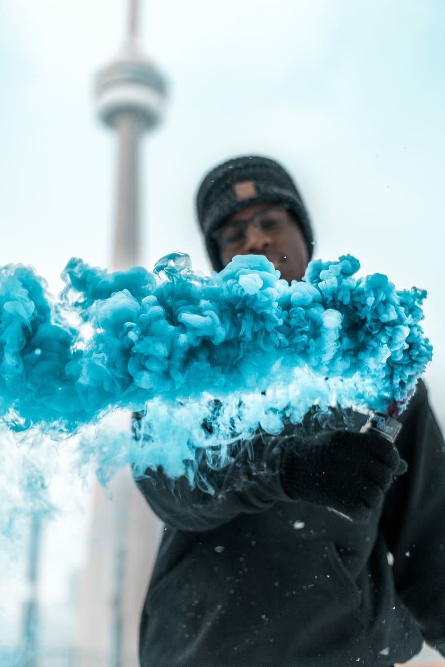 shallow focus photography of man, man holding blue smoke bomb HD wallpaper