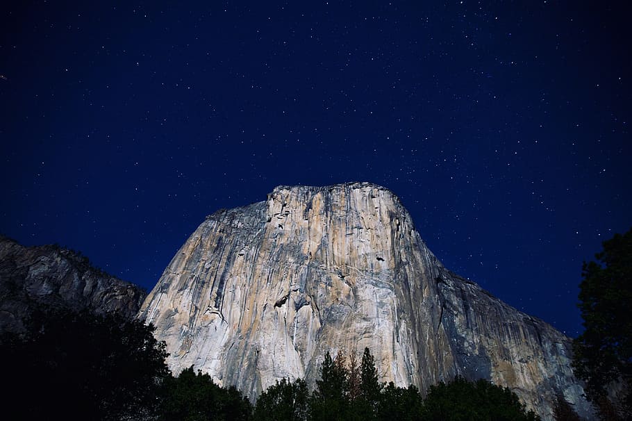 lowangle photography of gray mountains at nighttime, gray mountains under starry sky HD wallpaper