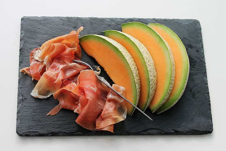 slice of bacon and fruits on rectangular black chopping board HD wallpaper