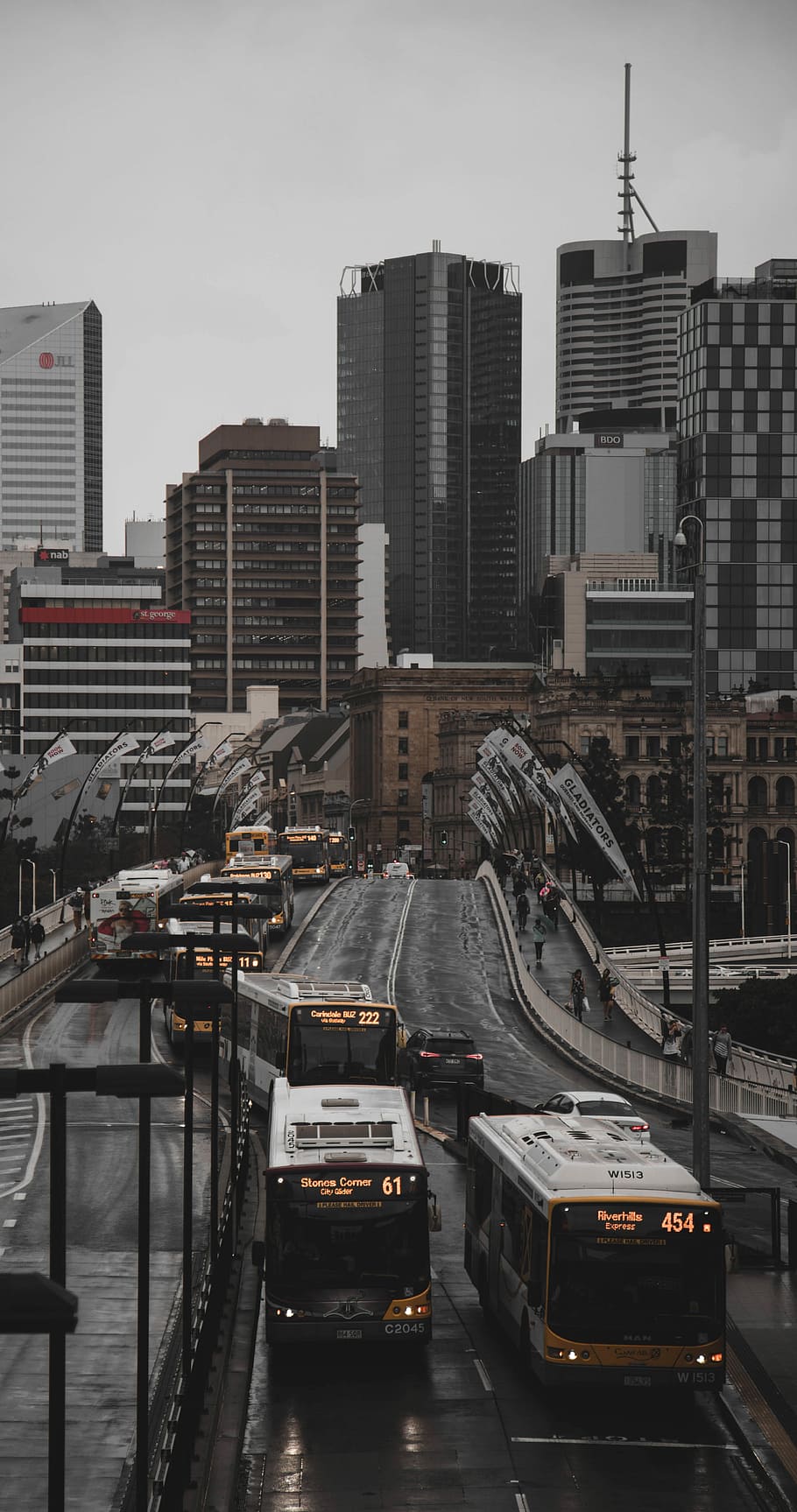 aerial photo of bus forming line while on road at daytime, white and brown bus on road near building HD wallpaper