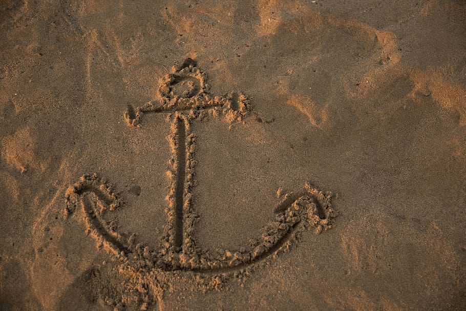 brown sand with drawn ship anchor, footprints, game, beach HD wallpaper