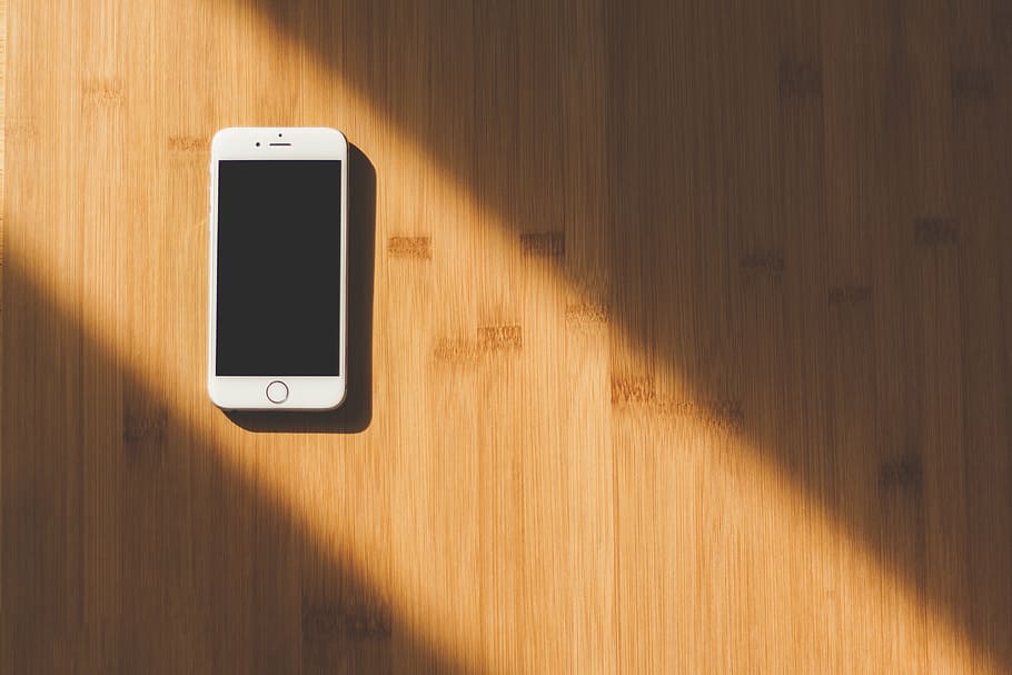 silver iPhone 6 on wooden surface, photo, gold, sunlight, brown