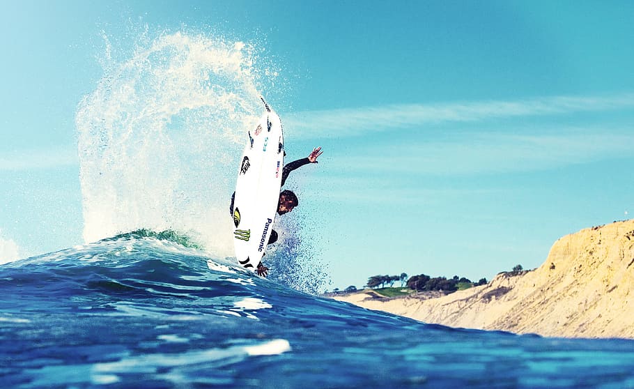man surfing near land, man riding wakeboard on body of water HD wallpaper