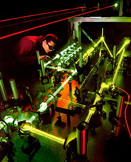 man holding tool near gray metal frame, laser, laser experiment HD wallpaper