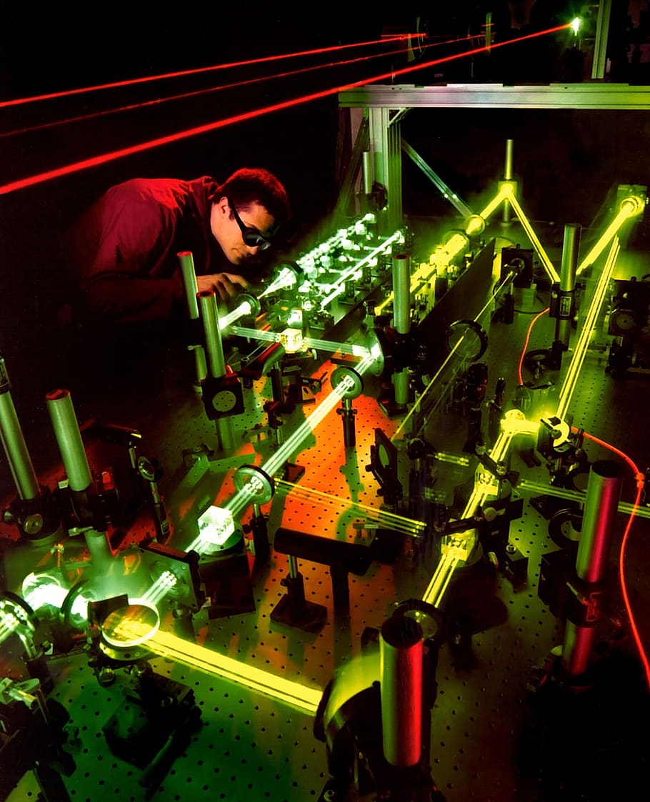man holding tool near gray metal frame, laser, laser experiment HD wallpaper