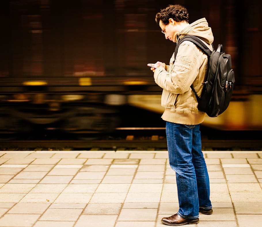 man standing white using smartphone, guy, platform, train station HD wallpaper