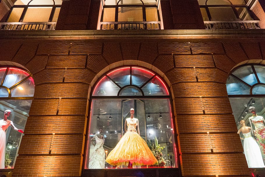 woman in orange dress statue, city, display window, evening HD wallpaper